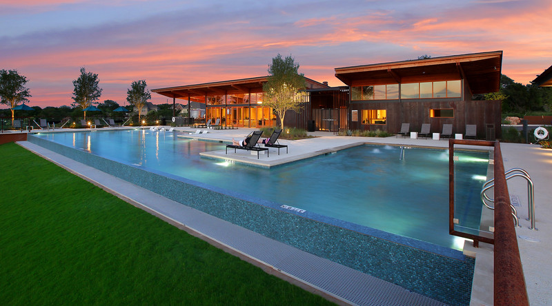 View of the Den amenity center at dusk with a beautiful sunset in background View of the Den amenity center at dusk with a beautiful sunset in background