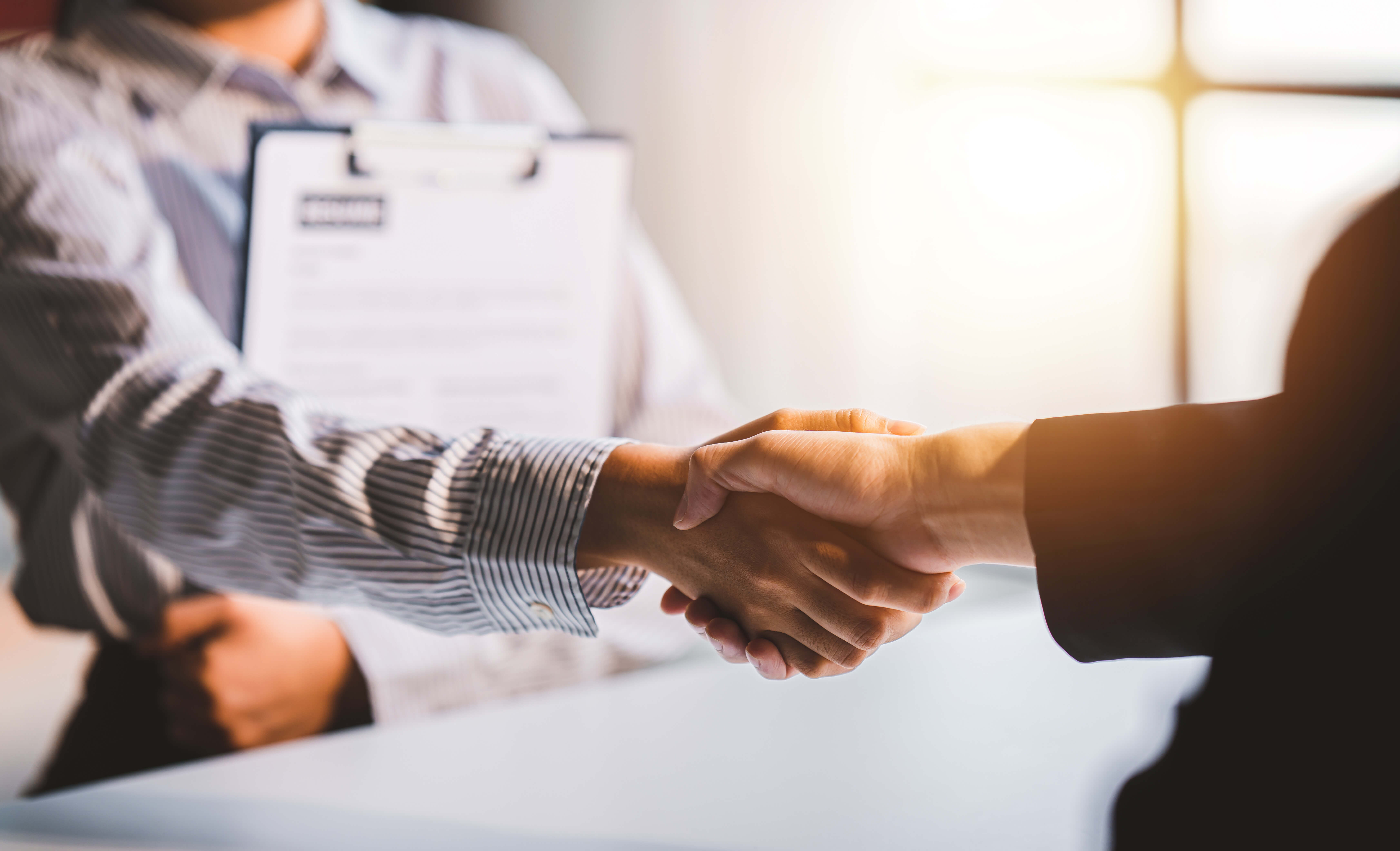 Employer and employee shaking hands after a job interview Employer and employee shaking hands after a job interview