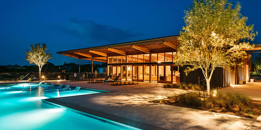 Outdoor pool at night with LED lighting at the Den amenity center Outdoor pool at night with LED lighting at the Den amenity center