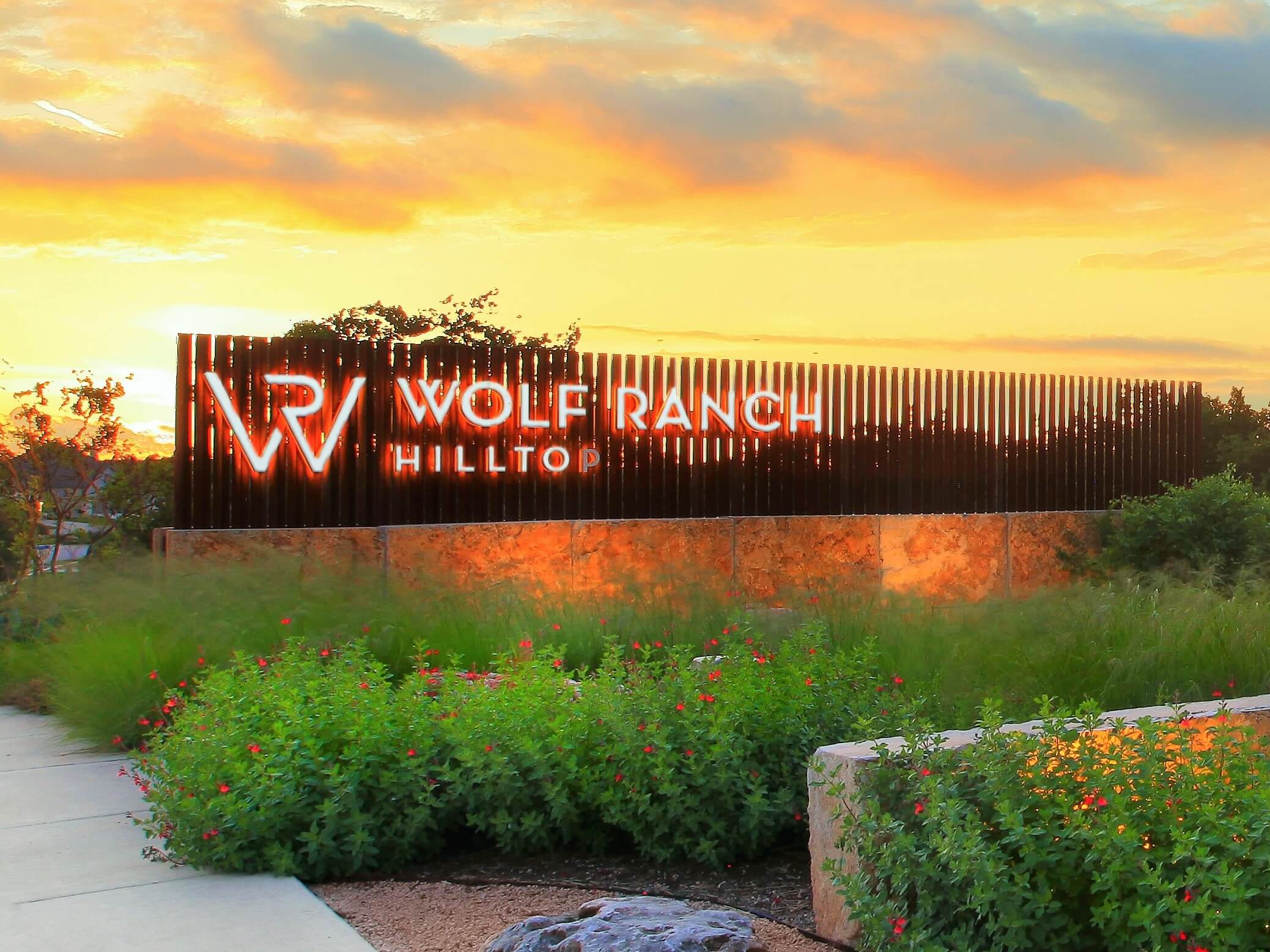 Wolf Ranch community entry sign at sunset Wolf Ranch community entry sign at sunset