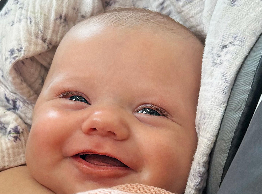 Photo of a smiling newborn baby Photo of a smiling newborn baby