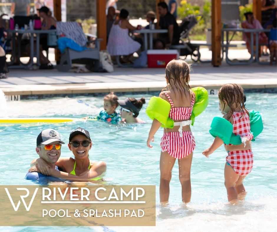 Children enjoying the River Camp pool splash pad on a warm summer day 